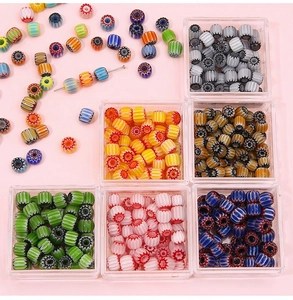 Macro detail of assorted 8mm millefiori glass beads in plastic boxes for DIY jewelry