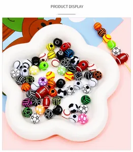 Close-up of sports themed acrylic beads in a ceramic tray for DIY jewelry making