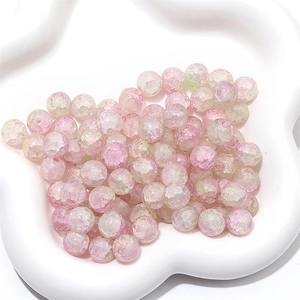Macro view of pink and green cracked glass beads for DIY jewelry making and crafts