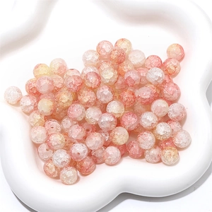 Macro detail of crackle glass beads in pink and orange gradients for DIY jewelry making