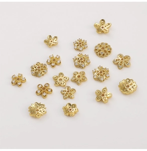 Macro shot of 14K gold-plated flower spacers with sparkling zircon for DIY jewelry making