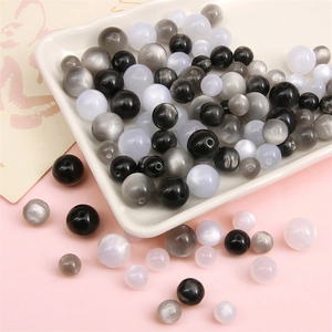 Polished cat-eye resin beads in black, grey, and white for DIY jewelry making