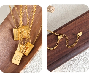 Detail of square letter gold pendant necklace showing lobster clasp and S.steel hallmark