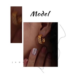 Detail view of gold mesh-style C-shaped hoop earrings with zircon on a model