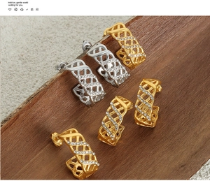 Detailed view of C-shaped hollow earrings with Czech crystals in gold and silver finish