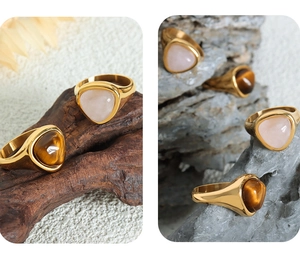 Macro detail of gold plated titanium steel ring featuring bezel-set tiger's eye stone
