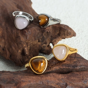 Elegant gold and silver titanium rings with triangular tiger eye and rose quartz stones