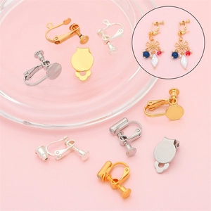 Golden and silver spiral ear clip converters for DIY jewelry making on pink background