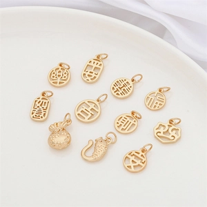 Detailed macro view of assorted gold koi and gourd charms with traditional Chinese symbols
