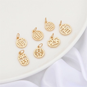 Close-up of golden Chinese hollow pendants with Fu and Double Happiness symbols