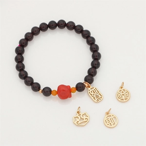 Detailed macro view of Chinese style lucky charms and red garnet beads for DIY jewelry