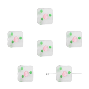 Detail of square frosted glass beads with green spots and pink flower pattern for DIY jewelry