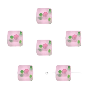 Macro detail of square frosted glass beads with colorful hand-painted swirling patterns