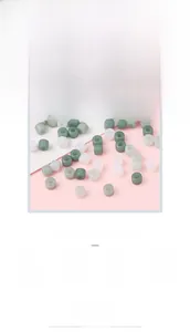 Detailed view of matte acrylic cylinder beads in mixed white and green colors for DIY crafts
