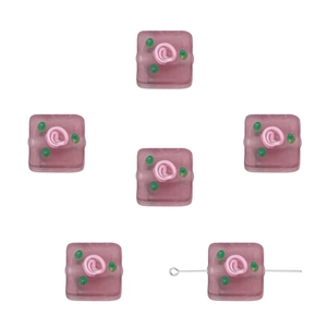 Detailed view of handmade frosted glass cube beads featuring pink rose flower patterns