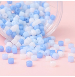 Macro shot of mixed blue and white acrylic cylinder beads for DIY jewelry making