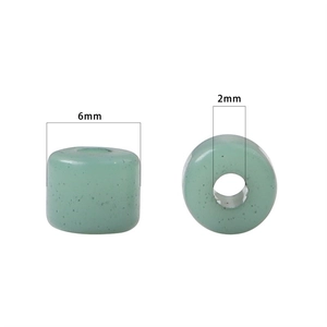 Light green acrylic cylinder beads with black speckles and size markings for DIY jewelry