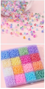 Detail of 4mm cat-eye glass beads in a 15-grid organizer box for DIY jewelry making