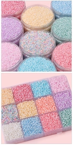 Macro shot of colorful glass seed beads in a transparent 12-slot organizer box and storage jar