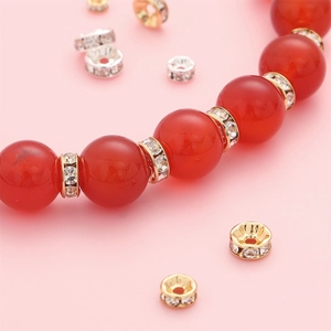 14K gold plated rhinestone spacer beads on a red carnelian beaded handmade bracelet
