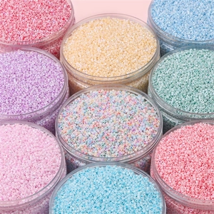 Colorful macaron glass seed beads in transparent jars for DIY jewelry making