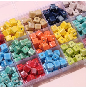 Close-up of 8mm colorful square ceramic beads in a grid box for DIY jewelry making