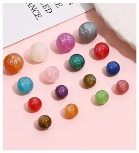 Macro detail of resin mermaid beads with starry gold dust for DIY jewelry making