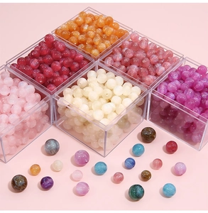 Close-up of sparkling mermaid resin beads in various candy colors for DIY jewelry making