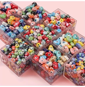 Macro shot of colorful ceramic evil eye beads in heart, star, and square shapes for DIY jewelry