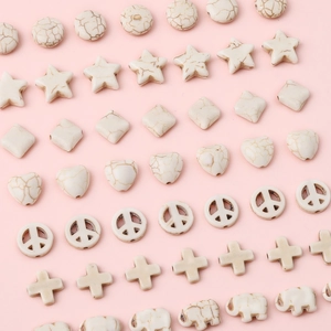 White turquoise stone beads in various shapes like stars and hearts for DIY jewelry making