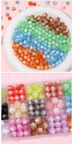 Close-up of colorful round cat-eye beads organized in a clear jewelry storage tray