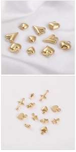 Macro view of 14K gold-filled charms including heart, star, and cross shapes for jewelry DIY