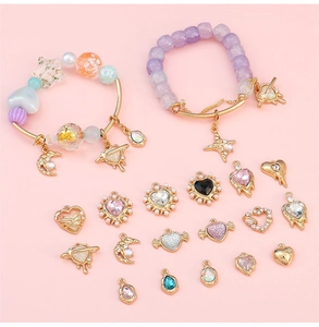 Flat lay of colorful crystal heart pendants and beads for DIY jewelry making sets