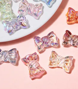 Detail of colorful aurora resin bow charms with pleated texture for DIY jewelry making