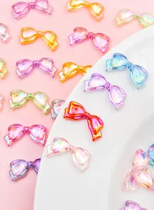 Macro shot of colorful aurora acrylic bow charms for DIY phone case and jewelry making