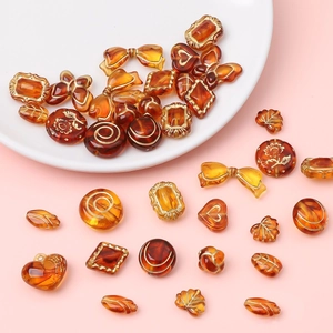 Ensemble de perles vintage en acrylique ambré avec détails dorés pour création de bijoux