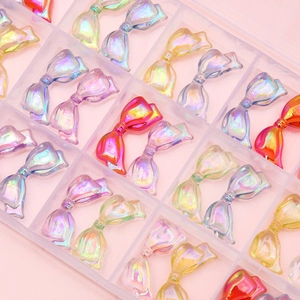 Colorful iridescent resin bow beads in transparent organizer box for DIY jewelry making