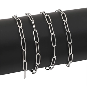 Polished silver stainless steel paperclip chain links wrapped on a black display stand