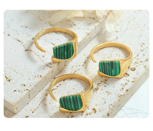Macro shot of gold adjustable open ring with malachite texture inlay and vintage design