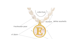 Macro detail of freshwater pearl necklace with gold letter E shell pendant and dimensions