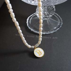 French style pearl necklace with gold letter B pendant and white shell inlay detail