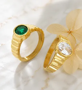 Macro detail of gold-plated rings featuring vertical grooves and inlaid crystal gemstones