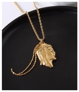 Detail of 18K gold plated necklace with Jesus portrait pendant and rope chain
