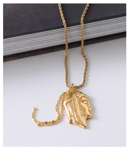 Detail showing portrait relief pendant with gold rope chain and bead link accents