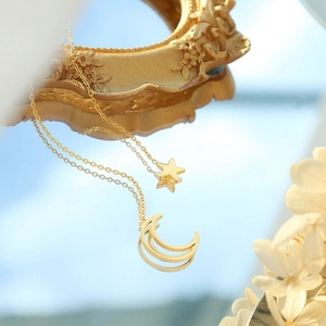Minimalist 18K gold plated celestial necklace with crescent moon and star charms