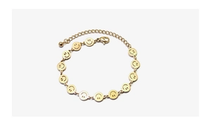 Detail of gold smiley face bracelet showing adjustable chain and lobster clasp closure