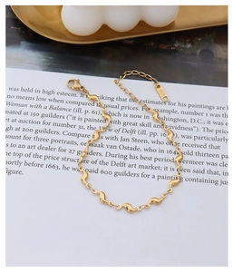 Détail du bracelet doré à texture ondulée 18K avec fermoir mousqueton et chaîne réglable