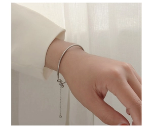 Detail of silver steel bead tassel bracelet with adjustable lobster clasp on wrist