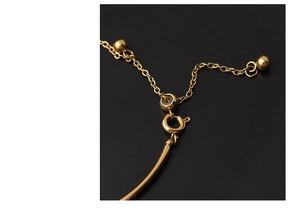 Macro shot of gold stainless steel spring clasp and adjustable chain with metal beads