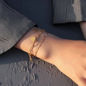 Double-layered 18K gold plated chain bracelet with heart tag and rabbit charm on wrist